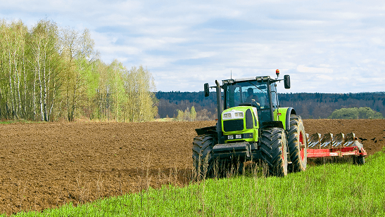 A tractor equipped with a plow is working in a field